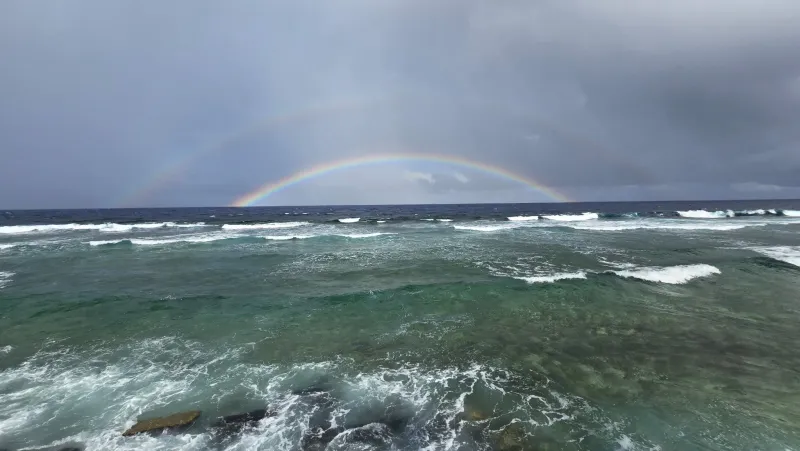 Double rainbow arching over the Pacific Ocean in Tuvalu.